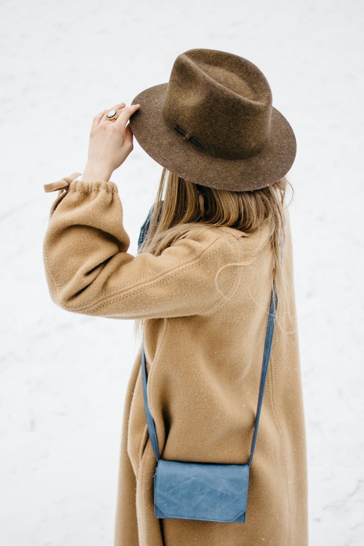 Woman in a camel wool coat and felt hat
