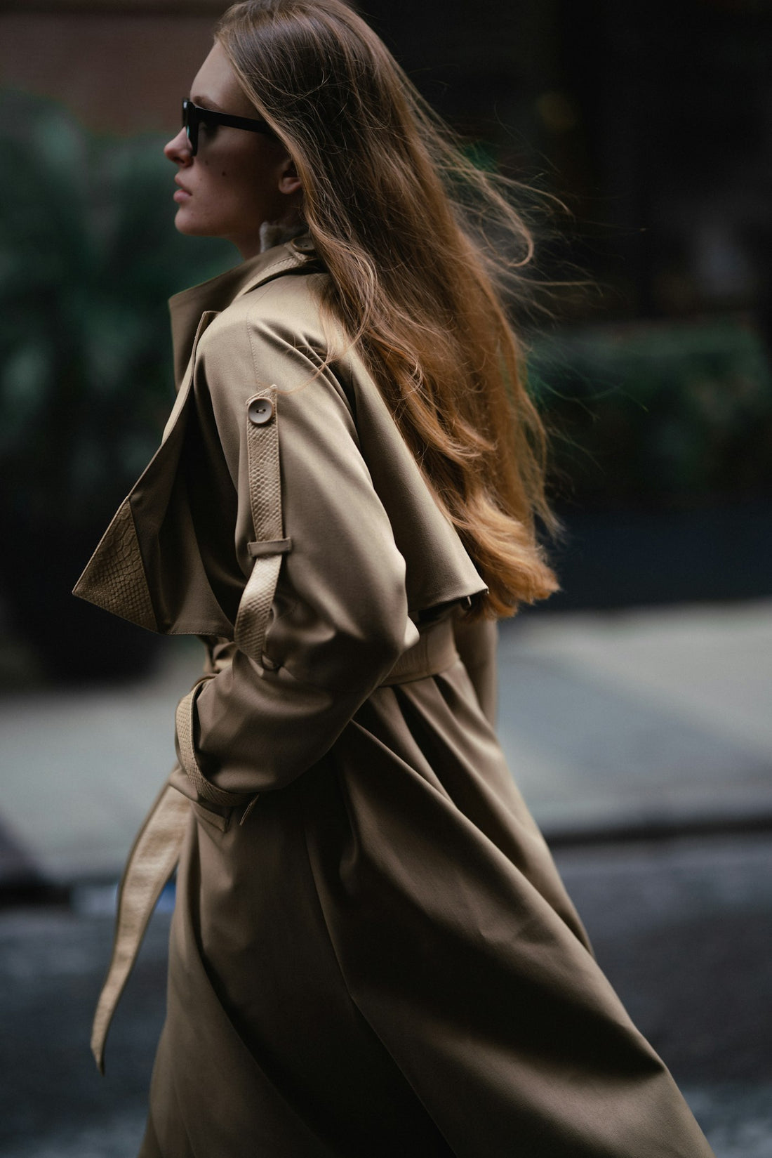 Woman in a long trench coat walking